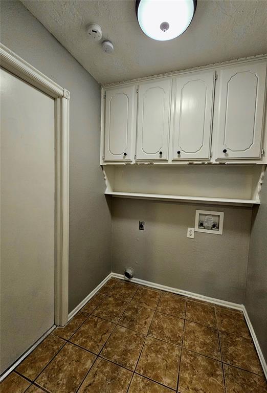 6013 Greenview Dr, Oklahoma City, OK 73135 - washroom featuring cabinet space, hookup for a washing machine, baseboards, electric dryer hookup, and dark tile patterned floors
