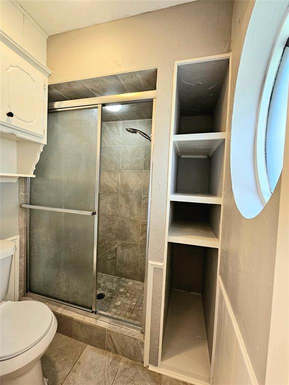 6013 Greenview Dr, Oklahoma City, OK 73135 - full bath with toilet, a stall shower, and tile patterned flooring