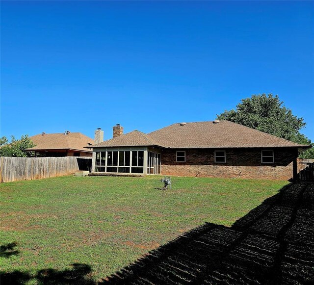6013 Greenview Dr, Oklahoma City, OK 73135 - back of house with a sunroom and a chimney