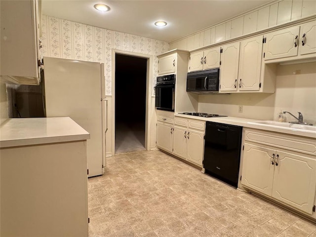 1618 NW 24th St, Lawton, OK 73505 - kitchen with black appliances, wallpapered walls, a sink, light countertops, and recessed lighting
