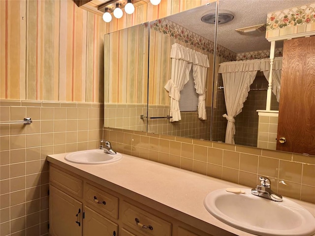 1618 NW 24th St, Lawton, OK 73505 - full bathroom featuring wallpapered walls, double vanity, decorative backsplash, and a textured ceiling