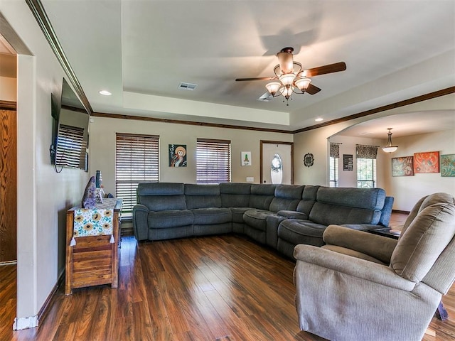 5509 Old Town St, Newalla, OK 74857 - living room featuring a raised ceiling, a ceiling fan, dark wood-style floors, baseboards, and arched walkways