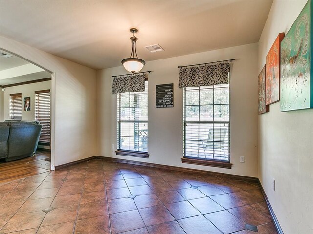 5509 Old Town St, Newalla, OK 74857 - unfurnished dining area featuring tile patterned flooring and baseboards