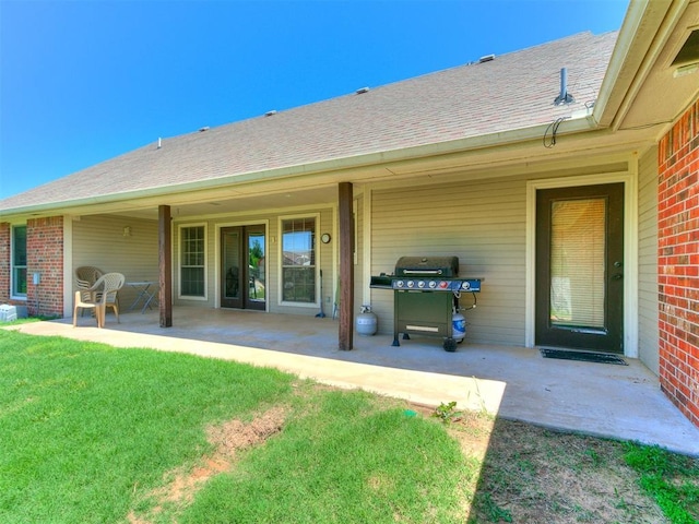 5509 Old Town St, Newalla, OK 74857 - back of property featuring a patio, brick siding, a shingled roof, and a yard