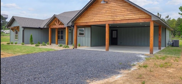 3155 E Fair St, Idabel, OK 74745 - view of front facade featuring a carport, central AC, driveway, and board and batten siding