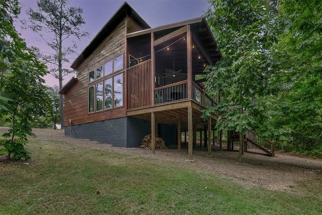 168 Eagle Mountain Trl, Broken Bow, OK 74728 - back of house with a sunroom, stairs, a lawn, and crawl space