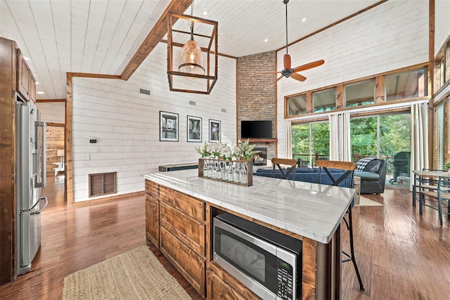 168 Eagle Mountain Trl, Broken Bow, OK 74728 - kitchen with stainless steel appliances, high vaulted ceiling, wood ceiling, open floor plan, and wooden walls