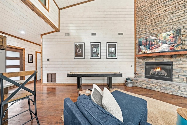 168 Eagle Mountain Trl, Broken Bow, OK 74728 - living room with wood finished floors, wood walls, a high ceiling, a stone fireplace, and recessed lighting