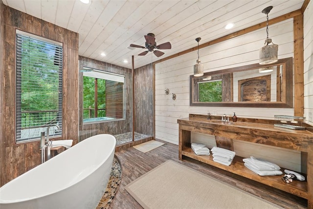 168 Eagle Mountain Trl, Broken Bow, OK 74728 - full bathroom with a freestanding bath, plenty of natural light, wooden walls, a walk in shower, and vanity