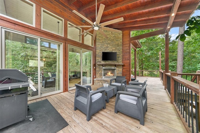 168 Eagle Mountain Trl, Broken Bow, OK 74728 - wooden deck featuring an outdoor stone fireplace, ceiling fan, and grilling area