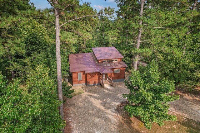 168 Eagle Mountain Trl, Broken Bow, OK 74728 - view of front of home with dirt driveway, metal roof, and a wooded view