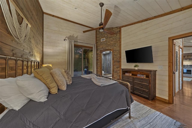 168 Eagle Mountain Trl, Broken Bow, OK 74728 - bedroom featuring wood walls, wood finished floors, access to exterior, wood ceiling, and a ceiling fan