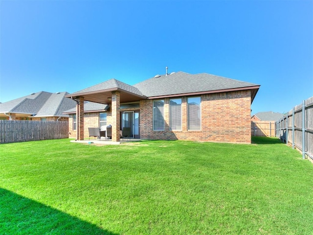 17016 Barcelona Dr, Oklahoma City, OK 73170 - back of house featuring brick siding, a patio, and roof with shingles