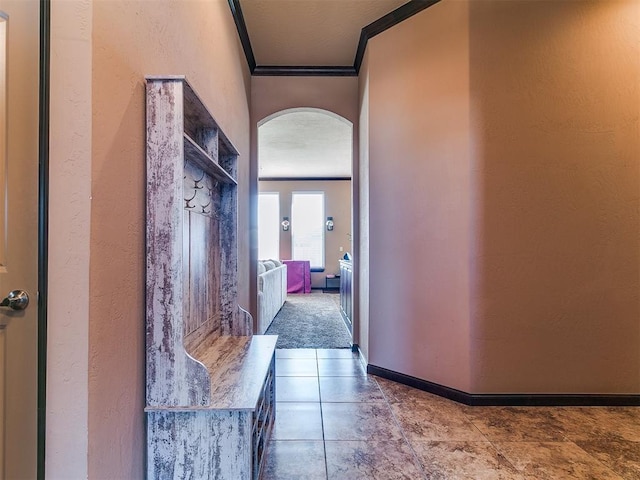 17016 Barcelona Dr, Oklahoma City, OK 73170 - corridor featuring crown molding, arched walkways, a textured wall, and baseboards