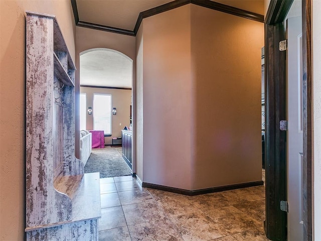 17016 Barcelona Dr, Oklahoma City, OK 73170 - hallway featuring crown molding, arched walkways, and baseboards