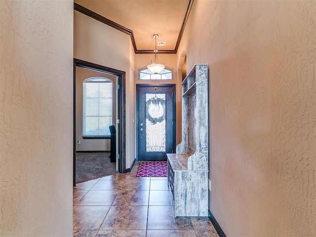 17016 Barcelona Dr, Oklahoma City, OK 73170 - entrance foyer featuring crown molding, a textured wall, tile patterned flooring, and baseboards
