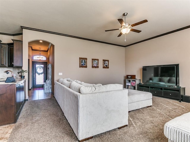 17016 Barcelona Dr, Oklahoma City, OK 73170 - living area with crown molding, arched walkways, a ceiling fan, and carpet floors