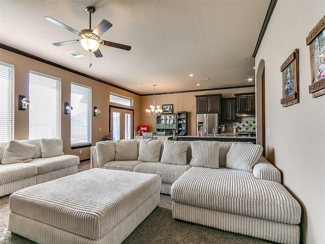 17016 Barcelona Dr, Oklahoma City, OK 73170 - living area with ornamental molding, a chandelier, dark carpet, ceiling fan, and arched walkways