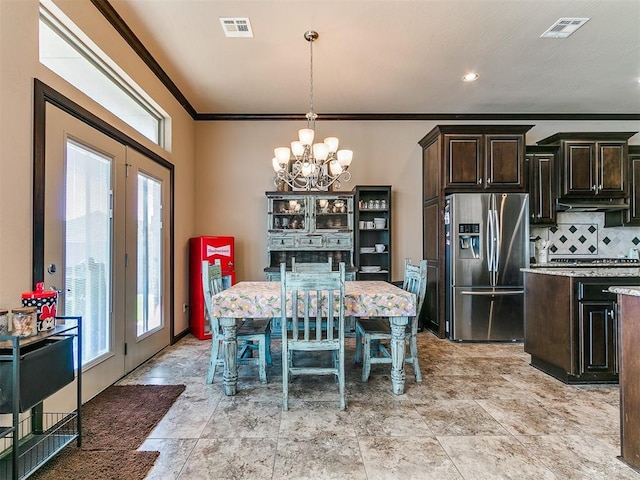 17016 Barcelona Dr, Oklahoma City, OK 73170 - dining area with a chandelier, crown molding, light stone finish floors, and french doors
