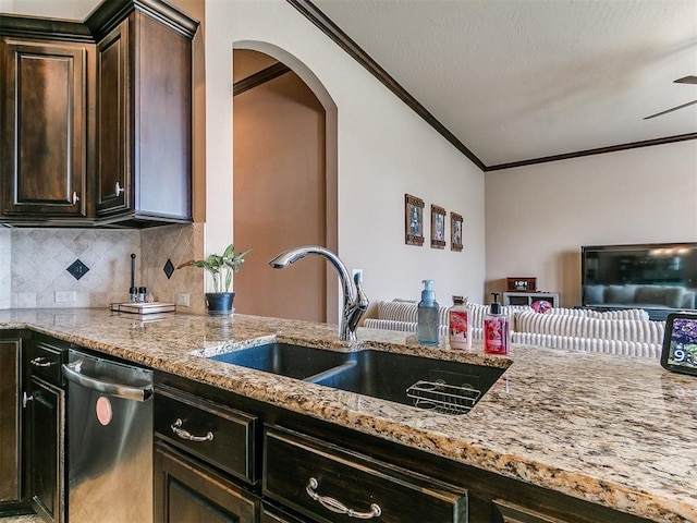 17016 Barcelona Dr, Oklahoma City, OK 73170 - kitchen with dishwasher, a sink, ornamental molding, light stone counters, and arched walkways