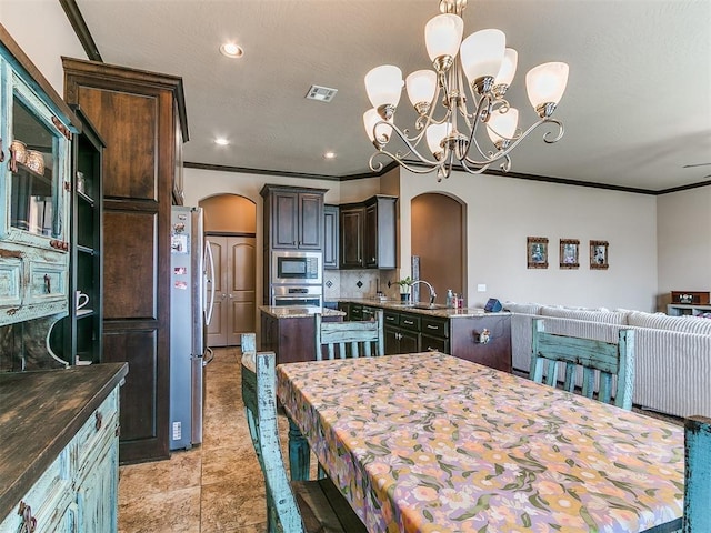 17016 Barcelona Dr, Oklahoma City, OK 73170 - dining space featuring arched walkways, crown molding, a chandelier, recessed lighting, and light tile patterned flooring