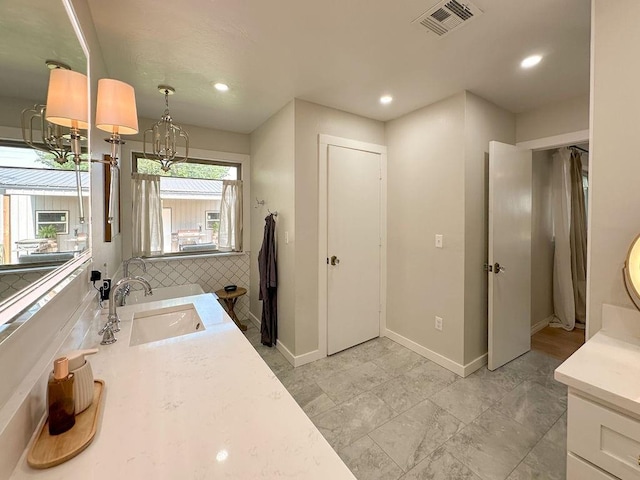 325 S Marion St, Hinton, OK 73047 - full bath featuring double vanity, baseboards, recessed lighting, and a chandelier