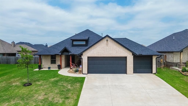10608 Wild Horse Creek Dr, Yukon, OK 73099 - view of front of house featuring a garage, driveway, brick siding, and a shingled roof