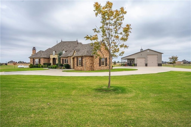 16000 SW 25th St, Oklahoma City, OK 73036 - french country inspired facade with a detached garage, a front yard, a chimney, and an outdoor structure