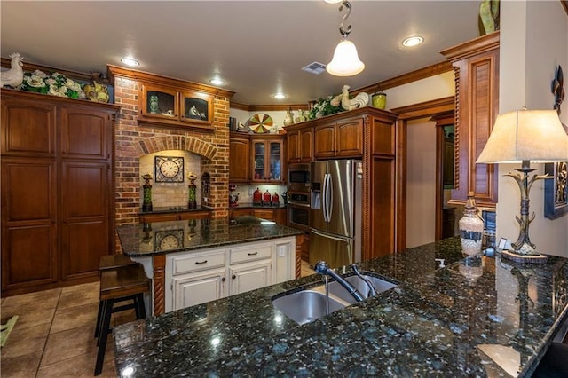 16000 SW 25th St, Oklahoma City, OK 73036 - kitchen featuring stainless steel appliances, a sink, glass insert cabinets, dark stone countertops, and light tile patterned floors