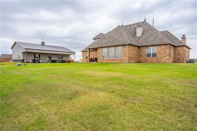 16000 SW 25th St, Oklahoma City, OK 73036 - back of house featuring a yard, brick siding, a chimney, and a shingled roof