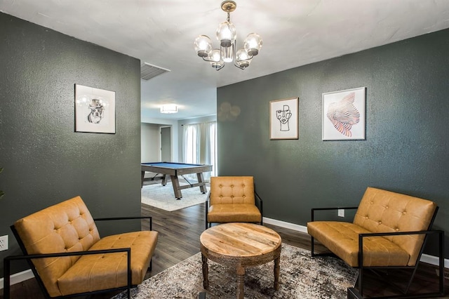 9800 Hummingbird Ln, Oklahoma City, OK 73162 - sitting room featuring a textured wall, billiards, wood finished floors, a chandelier, and baseboards