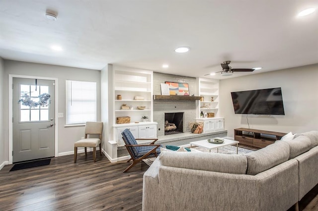 9800 Hummingbird Ln, Oklahoma City, OK 73162 - living area with baseboards, dark wood-style flooring, ceiling fan, a fireplace, and recessed lighting