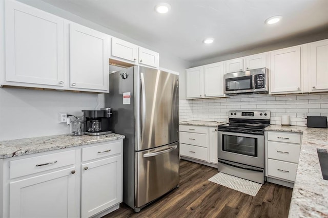 9800 Hummingbird Ln, Oklahoma City, OK 73162 - kitchen featuring appliances with stainless steel finishes, white cabinets, dark wood-style floors, decorative backsplash, and recessed lighting