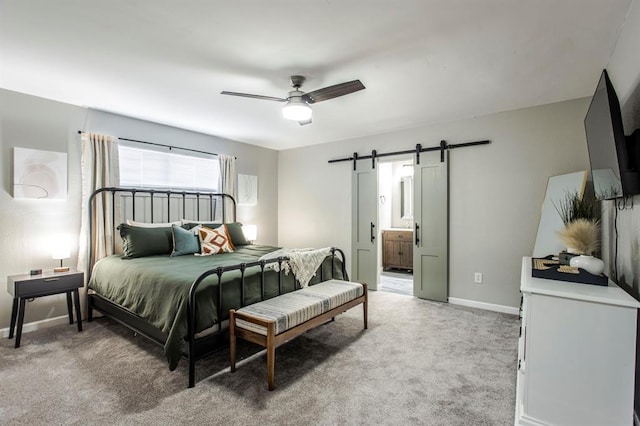 9800 Hummingbird Ln, Oklahoma City, OK 73162 - bedroom featuring a barn door, light carpet, baseboards, connected bathroom, and ceiling fan