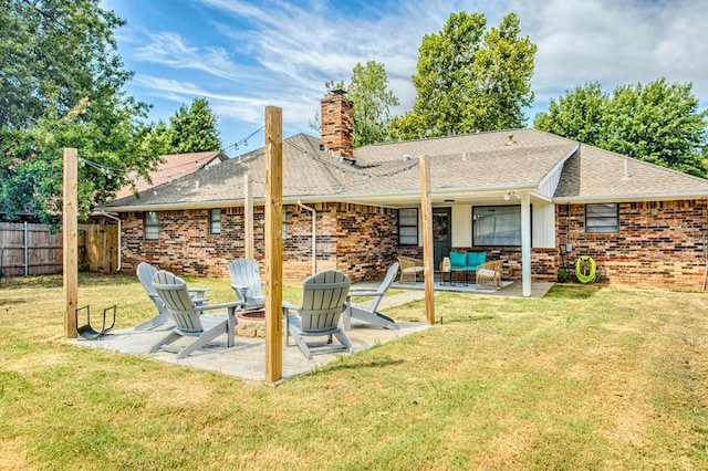 9800 Hummingbird Ln, Oklahoma City, OK 73162 - back of property featuring a chimney, a patio area, an outdoor living space with a fire pit, brick siding, and a shingled roof