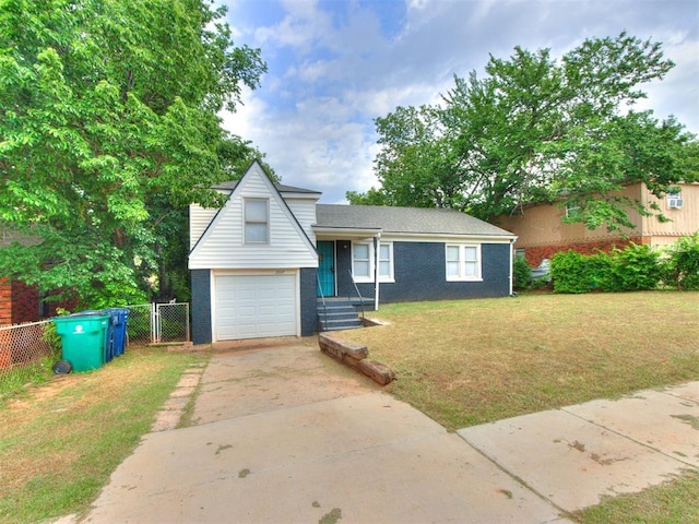 2107 NE 26th St, Oklahoma City, OK 73111 - split level home with driveway, brick siding, and a garage