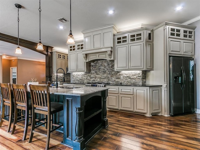 4216 SE 86th Pl, Oklahoma City, OK 73135 - kitchen with black fridge, ornamental molding, dark wood finished floors, a sink, and tasteful backsplash
