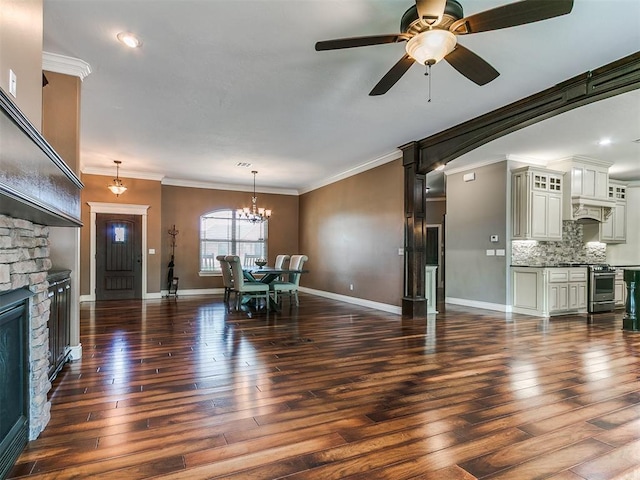 4216 SE 86th Pl, Oklahoma City, OK 73135 - living room featuring crown molding, dark wood finished floors, a fireplace, baseboards, and a chandelier