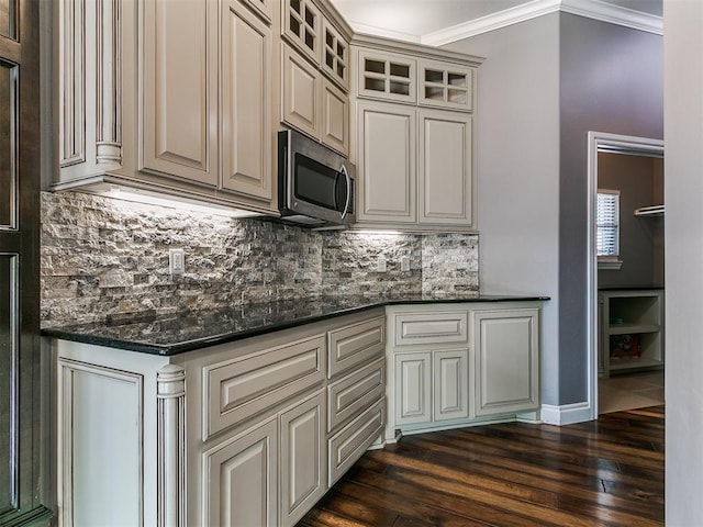 4216 SE 86th Pl, Oklahoma City, OK 73135 - kitchen featuring stainless steel microwave, decorative backsplash, glass insert cabinets, dark wood-style floors, and crown molding