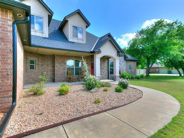 4216 SE 86th Pl, Oklahoma City, OK 73135 - view of front facade featuring a shingled roof, a front yard, brick siding, stucco siding, and covered porch