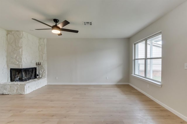 812 NW 113th St, Oklahoma City, OK 73114 - unfurnished living room featuring a ceiling fan, light wood-style flooring, baseboards, and a fireplace