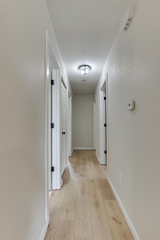 812 NW 113th St, Oklahoma City, OK 73114 - corridor featuring light wood-style floors and baseboards