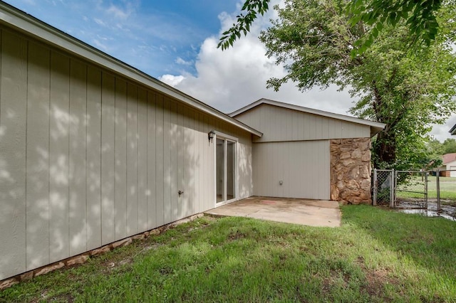 812 NW 113th St, Oklahoma City, OK 73114 - view of property exterior featuring a patio area, a gate, and stone siding