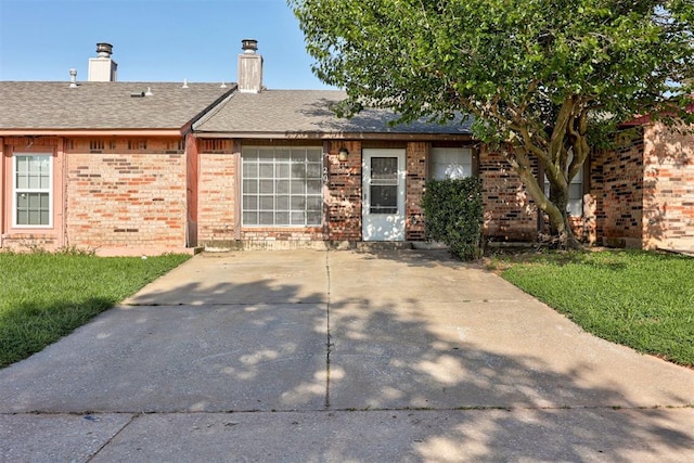 201 Kathleen Dr, Midwest City, OK 73110 - single story home with brick siding, a chimney, a front lawn, and roof with shingles
