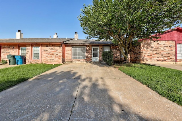 201 Kathleen Dr, Midwest City, OK 73110 - single story home with brick siding, a front yard, and a chimney