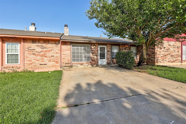 201 Kathleen Dr, Midwest City, OK 73110 - ranch-style house with brick siding, a front yard, and a chimney