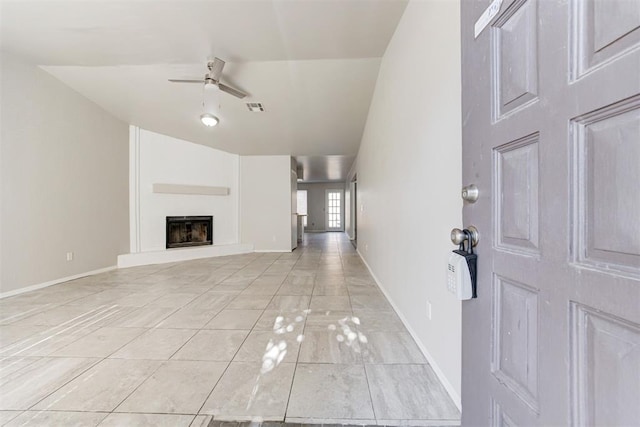201 Kathleen Dr, Midwest City, OK 73110 - unfurnished living room featuring a ceiling fan, baseboards, a fireplace with raised hearth, lofted ceiling, and light marble finish floors