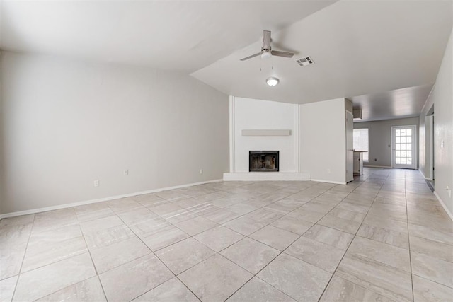 201 Kathleen Dr, Midwest City, OK 73110 - unfurnished living room with ceiling fan, light tile patterned floors, a fireplace with raised hearth, vaulted ceiling, and baseboards