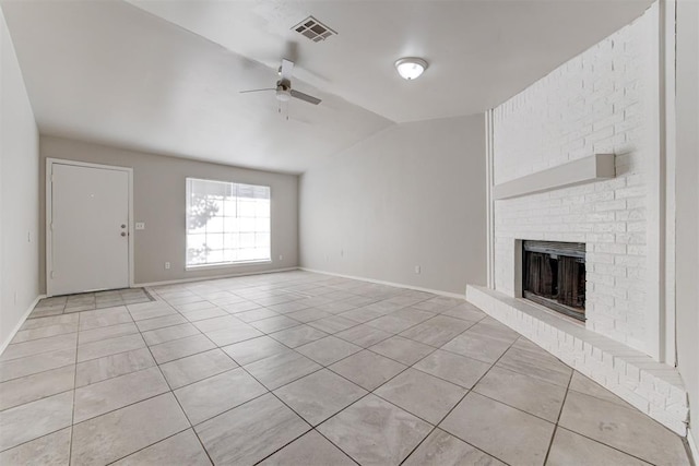201 Kathleen Dr, Midwest City, OK 73110 - unfurnished living room featuring light tile patterned floors, lofted ceiling, ceiling fan, a brick fireplace, and baseboards