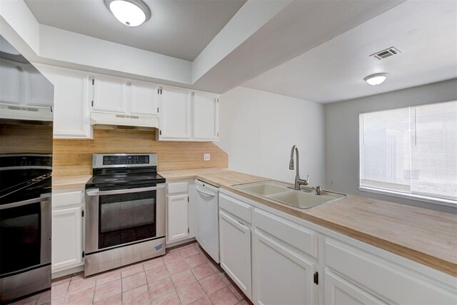 201 Kathleen Dr, Midwest City, OK 73110 - kitchen with stainless steel electric range oven, dishwasher, under cabinet range hood, a sink, and light countertops
